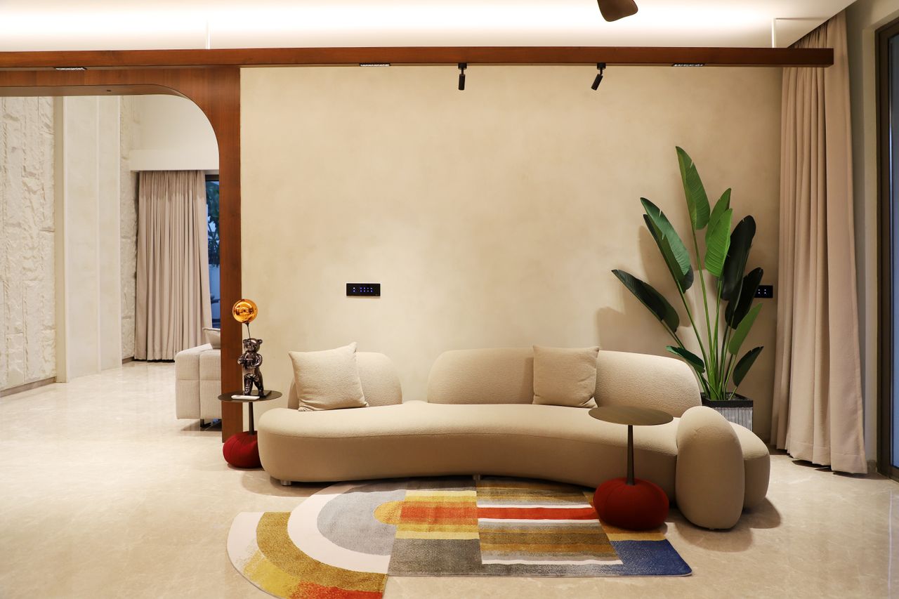 Stylish living room featuring modern sofa, plant, and colorful rug for a chic aesthetic.